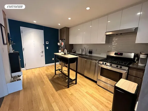 a kitchen with stainless steel appliances granite countertop a stove a sink a refrigerator and a microwave