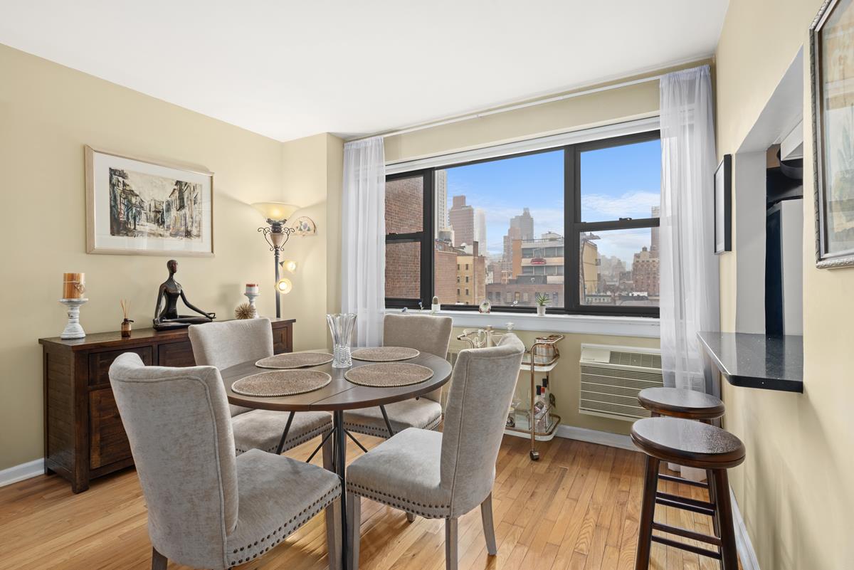357 East 57th Street, Unit 10G Manhattan, NY 10022 - Photo 1 of 9 a view of a dining room with furniture window and outside view