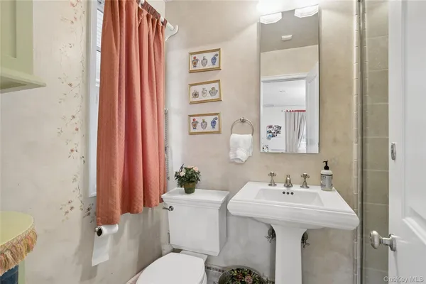 a bathroom with a sink toilet and shower
