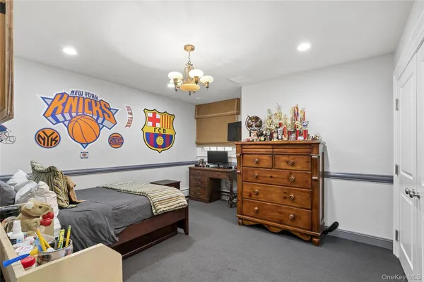 a bedroom with a bed and a dresser in it