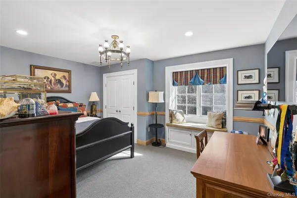 a bedroom with furniture and a large window