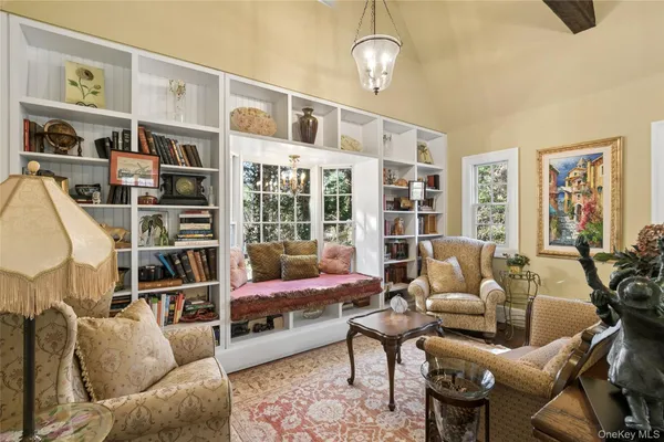 a living room with furniture a rug and a large window