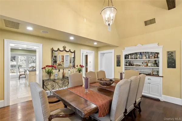 a view of a dining room with furniture wooden floor and chandelier
