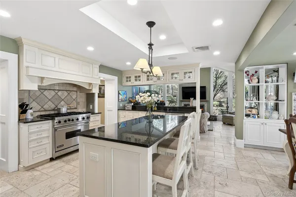a kitchen with stainless steel appliances granite countertop a stove oven and a sink with cabinets