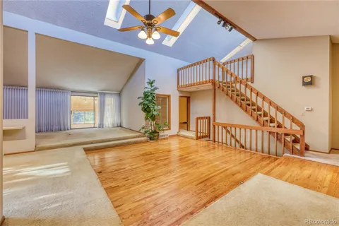 a kitchen with stainless steel appliances granite countertop a sink dishwasher stove and cabinets with wooden floor