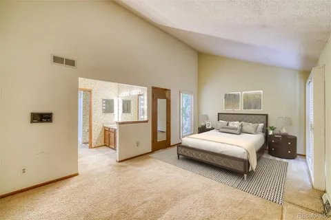 a bathroom with a granite countertop sink a mirror and a shower
