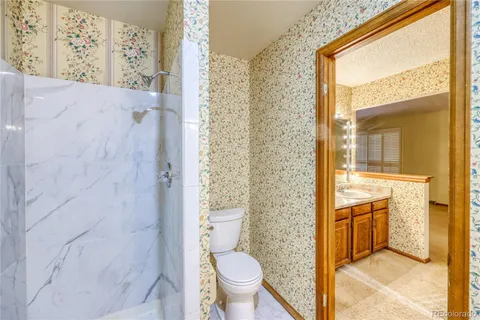 a bedroom with a bed and a potted plant next to a window
