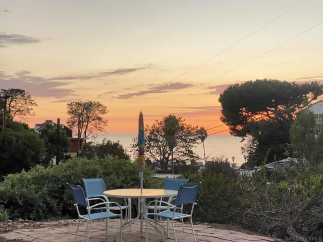 a patio with wooden fence and city view