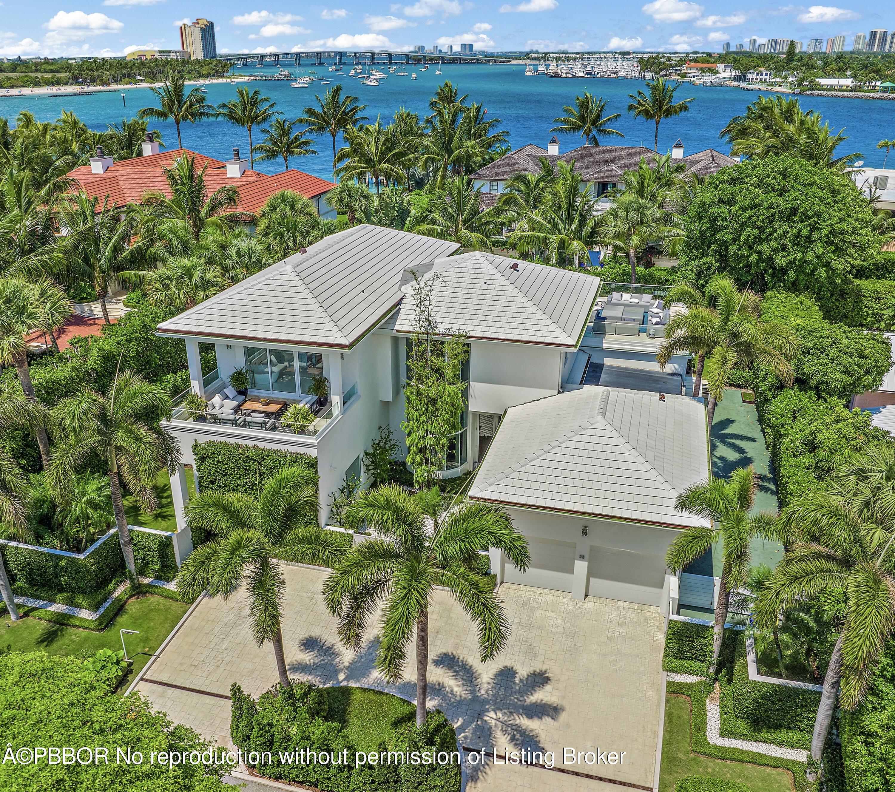 an aerial view of a house with a garden and lake view