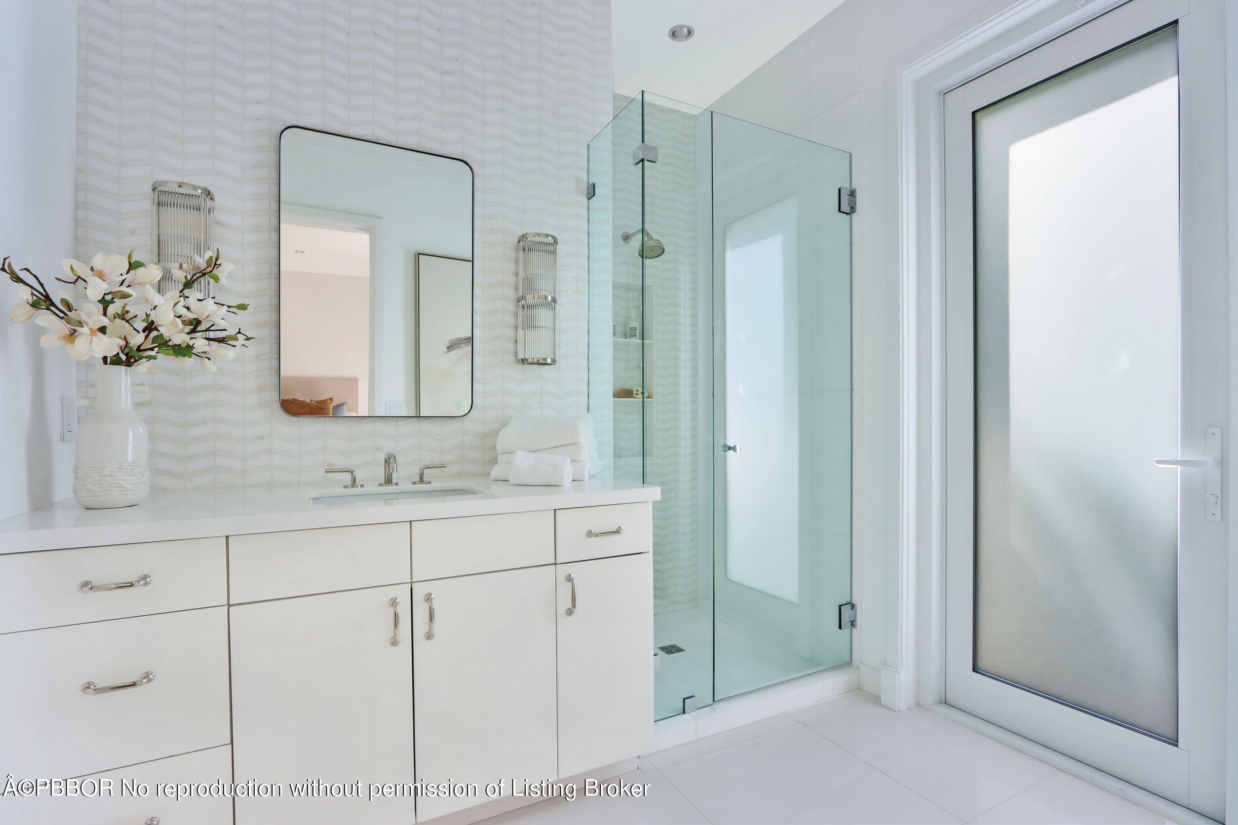 215 Indian Road Palm Beach, FL 33480 - Photo 18 of 32 a bathroom with a shower sink and mirror