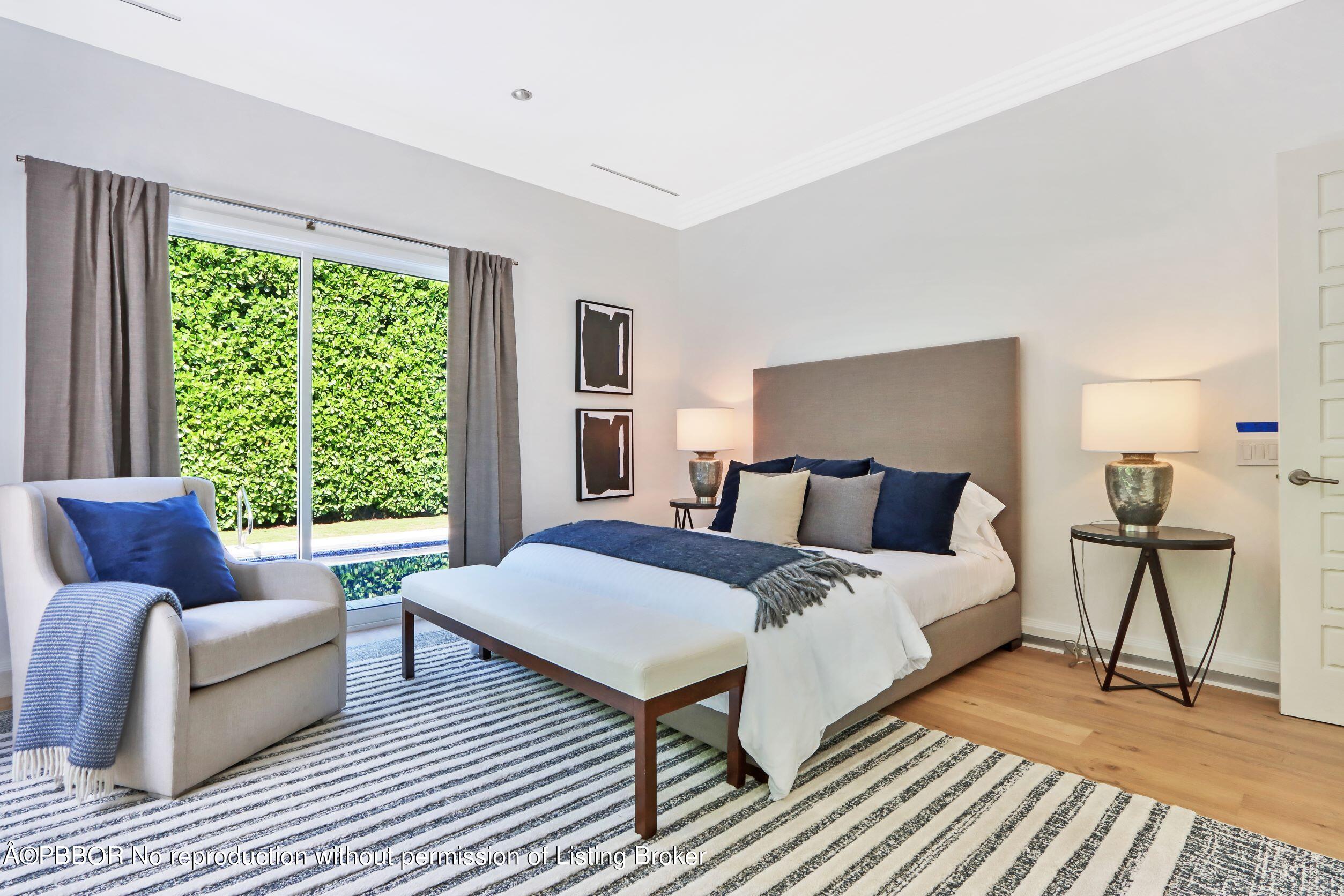 215 Indian Road Palm Beach, FL 33480 - Photo 22 of 32 a spacious bedroom with a bed couch and a window
