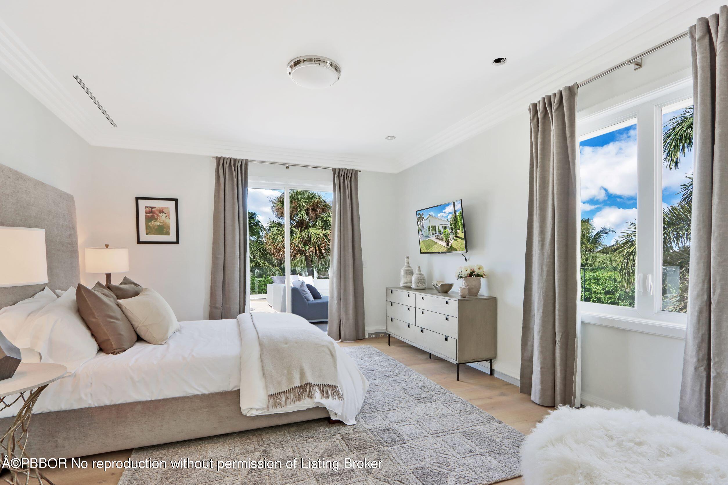 215 Indian Road Palm Beach, FL 33480 - Photo 23 of 32 a spacious bedroom with a bed and large windows