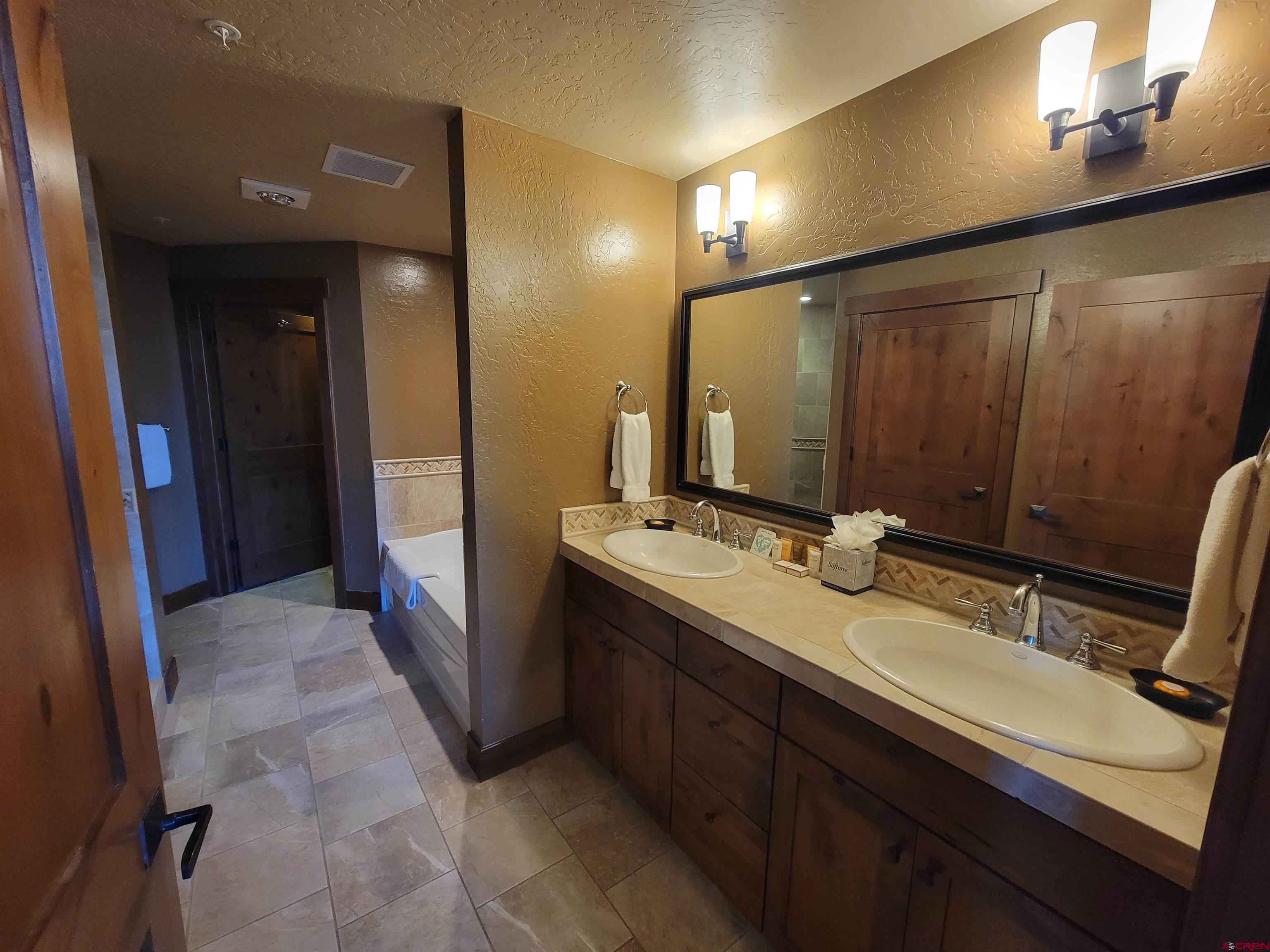 24 Sheol Street, Unit 101D Durango, CO 81301 - Photo 11 of 32 a bathroom with a double vanity sink and a mirror