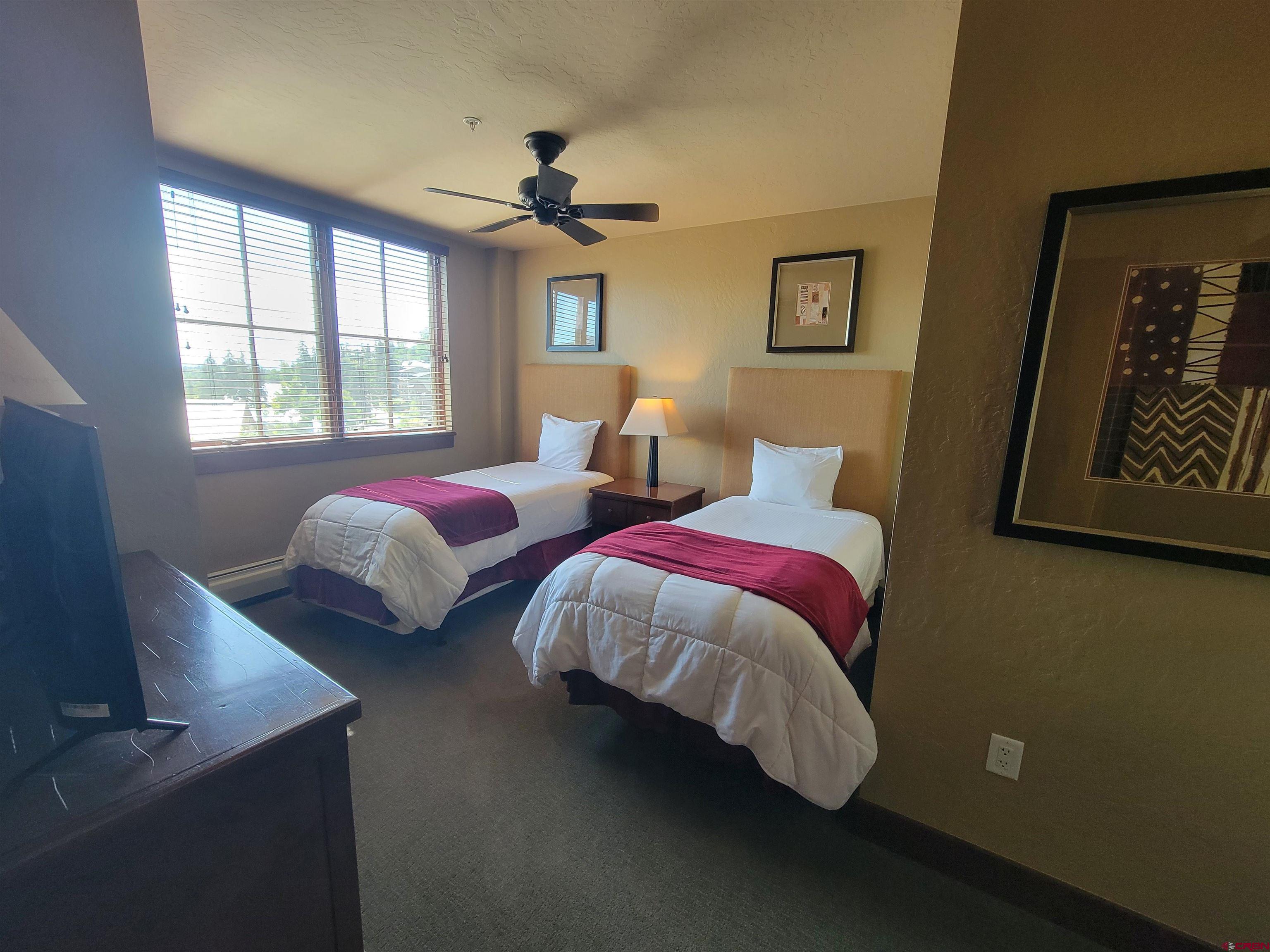 24 Sheol Street, Unit 101D Durango, CO 81301 - Photo 19 of 32 a bedroom with two beds and painting on the wall