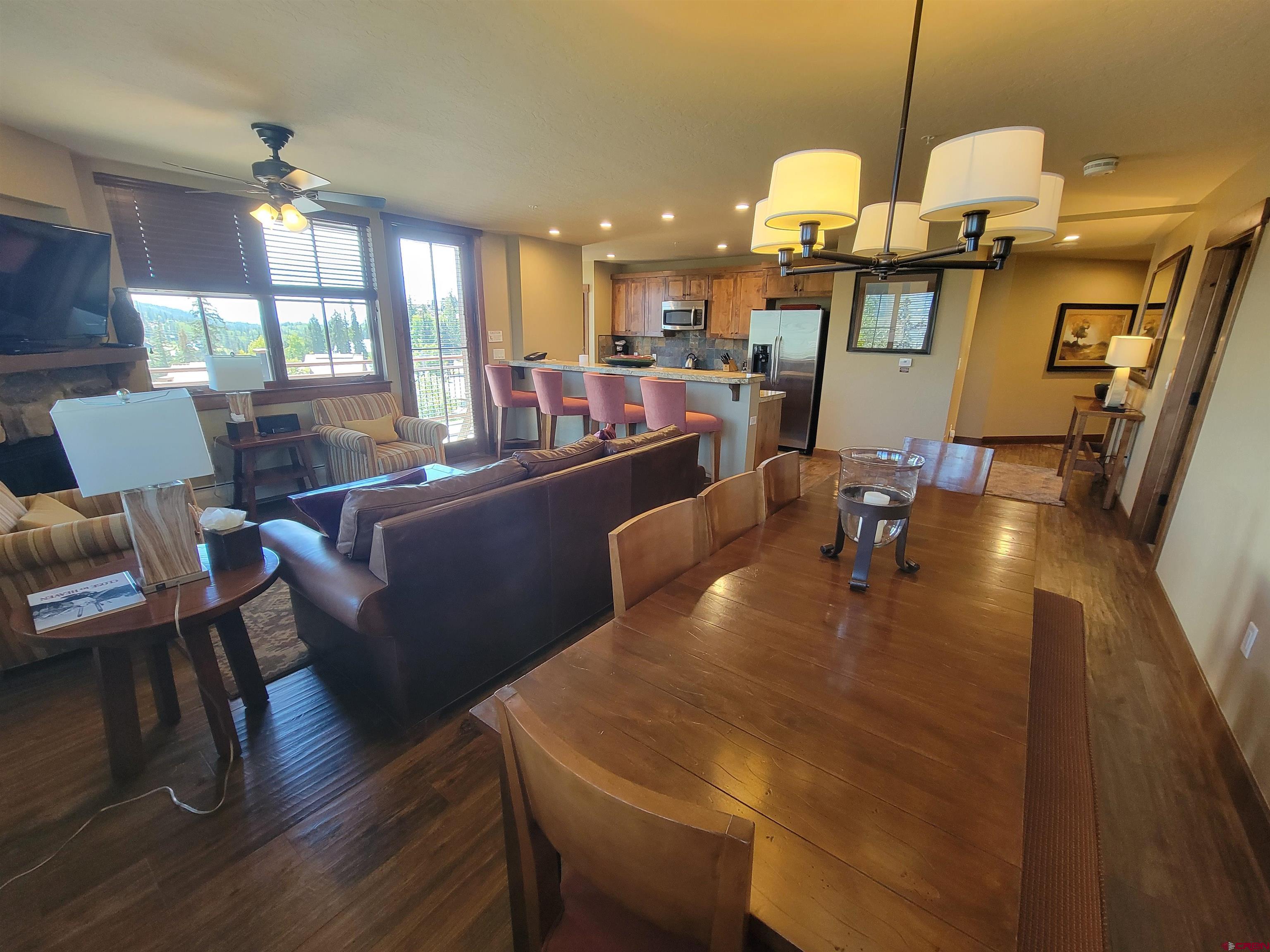 24 Sheol Street, Unit 101D Durango, CO 81301 - Photo 5 of 32 a dining room with wooden floor a glass table and chairs