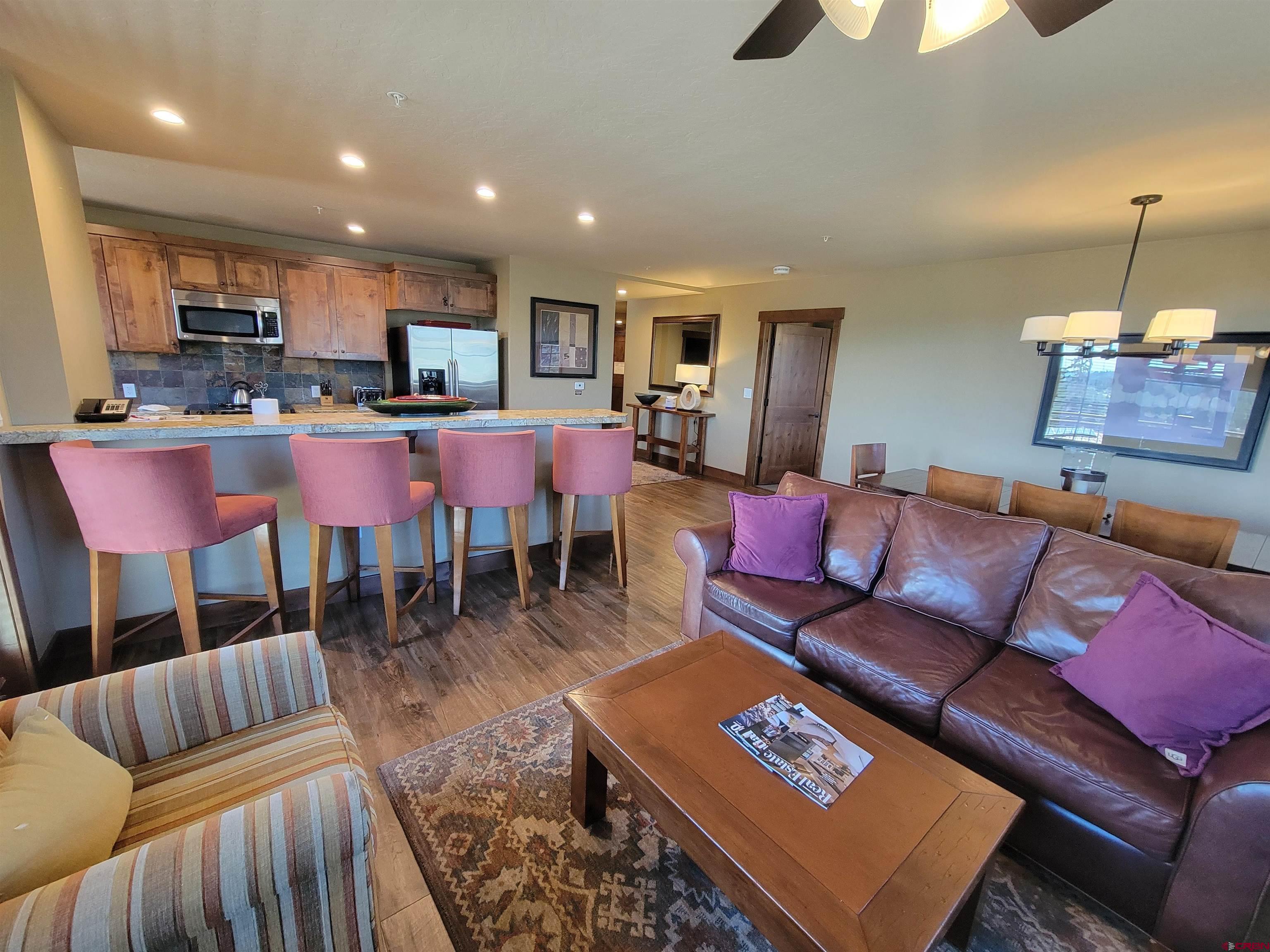 24 Sheol Street, Unit 101D Durango, CO 81301 - Photo 6 of 32 a living room with furniture a rug and kitchen view