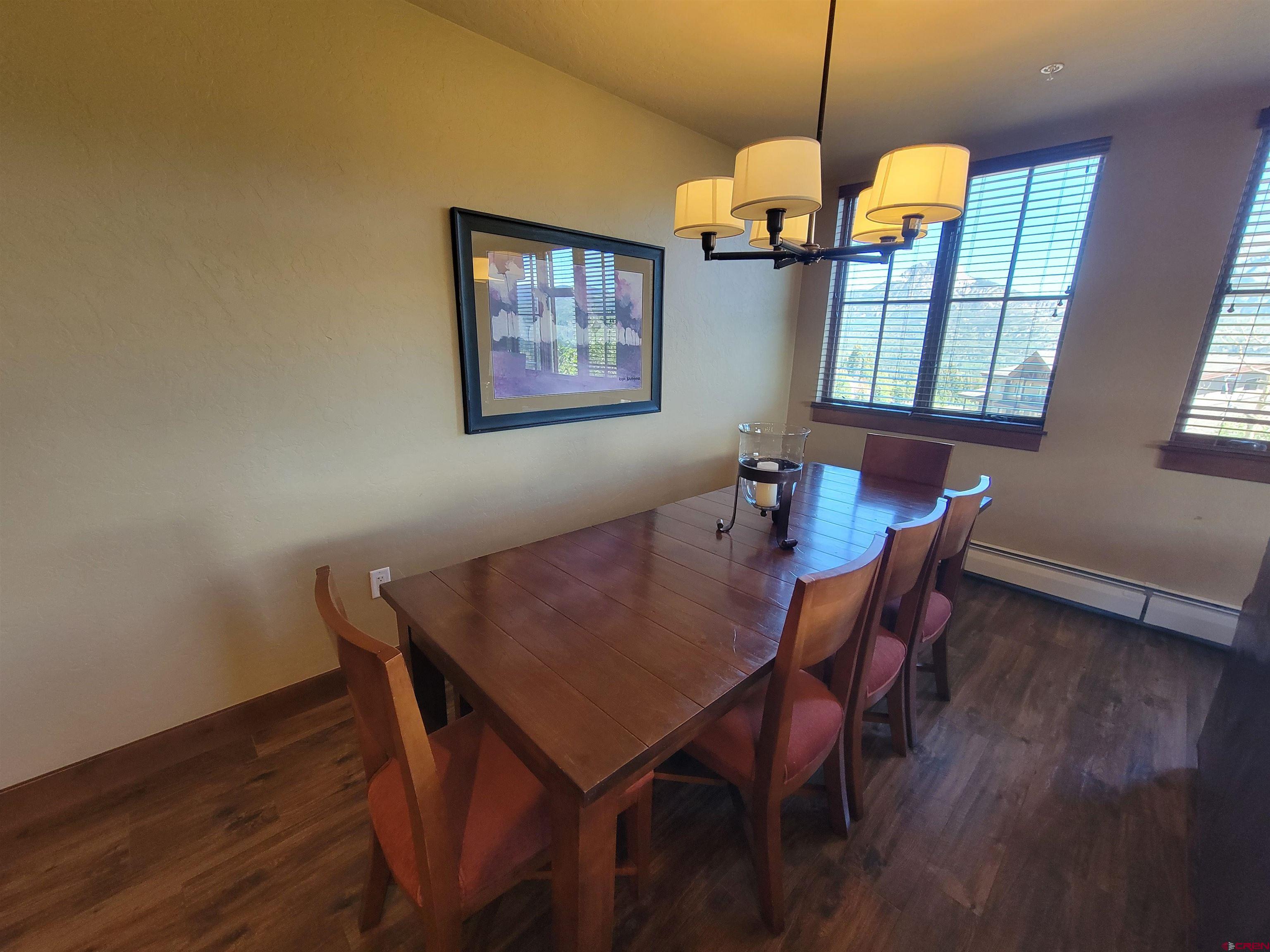 24 Sheol Street, Unit 101D Durango, CO 81301 - Photo 8 of 32 a dining room with furniture a chandelier and wooden floor