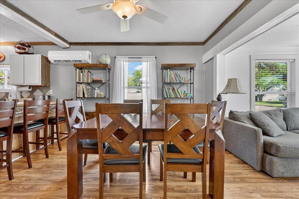 124 West Travis Dublin, TX 76446 - Photo 11 of 30 a view of a dining room with furniture window and wooden floor