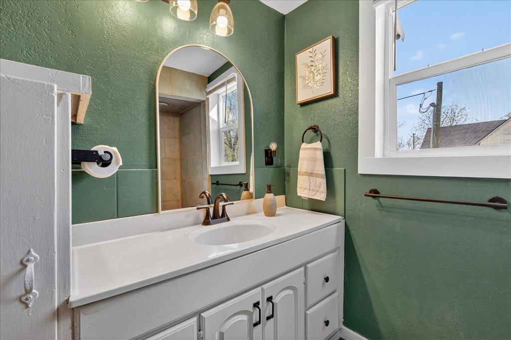 124 West Travis Dublin, TX 76446 - Photo 19 of 30 a bathroom with a sink and a mirror