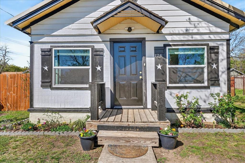 124 West Travis Dublin, TX 76446 - Photo 2 of 30 a front view of a house with potted plants
