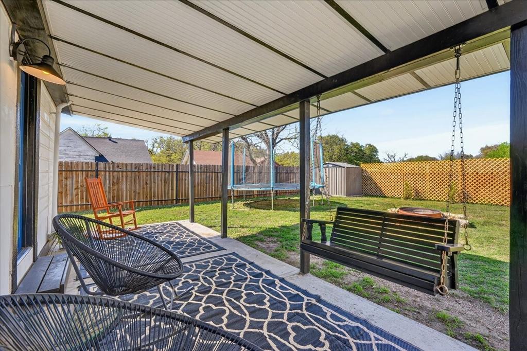 124 West Travis Dublin, TX 76446 - Photo 22 of 30 a view of a patio with a table chairs and wooden fence