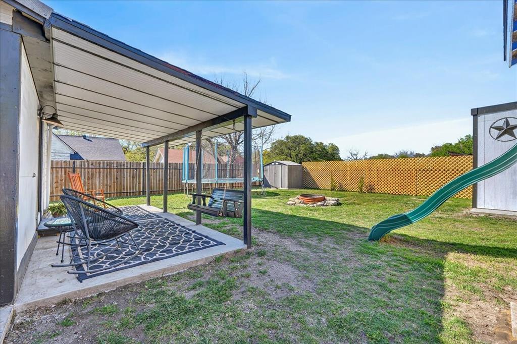 124 West Travis Dublin, TX 76446 - Photo 23 of 30 a view of a backyard with a slide
