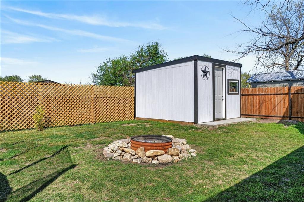 124 West Travis Dublin, TX 76446 - Photo 25 of 30 a view of a backyard with large tree