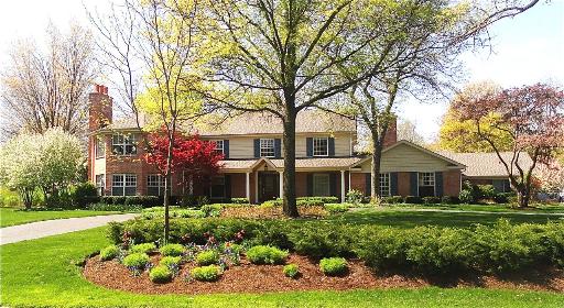 348 Firth Road Inverness, IL 60067 - Photo 1 of 16 a front view of a house with a garden and trees