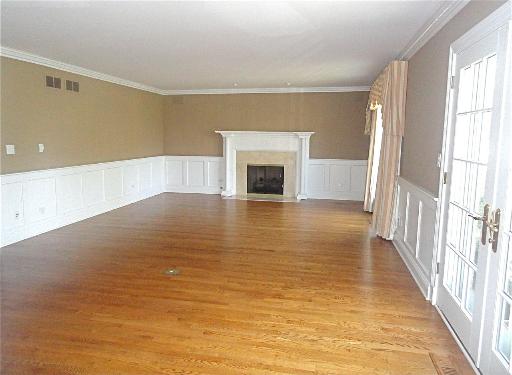 348 Firth Road Inverness, IL 60067 - Photo 2 of 16 a view of a livingroom with wooden floor and a fireplace