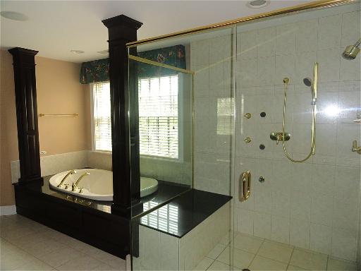 348 Firth Road Inverness, IL 60067 - Photo 12 of 16 a bathroom with a bathtub and shower