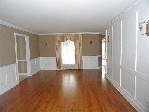 348 Firth Road Inverness, IL 60067 - Photo 3 of 16 wooden floor in an empty room with a window