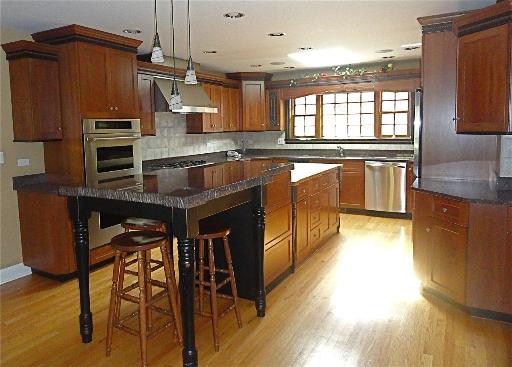 348 Firth Road Inverness, IL 60067 - Photo 5 of 16 a kitchen with stainless steel appliances granite countertop a sink a stove and a wooden floors
