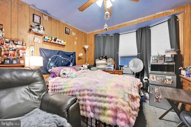 a bedroom with a bed a couch and dresser