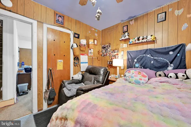 a bedroom with bed and wooden floor