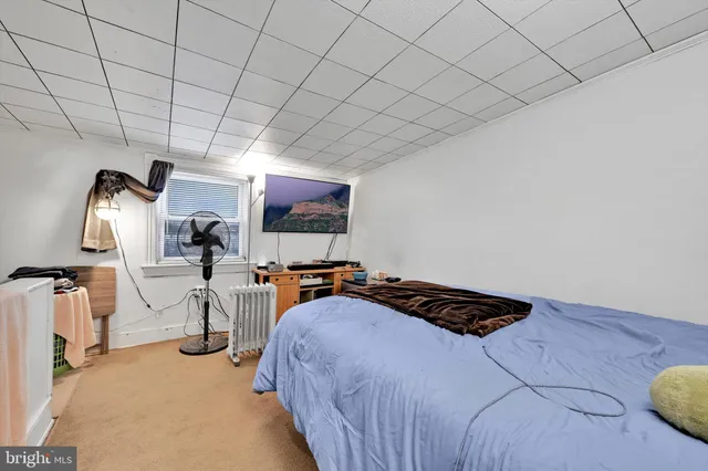 a bedroom with furniture and a flat screen tv