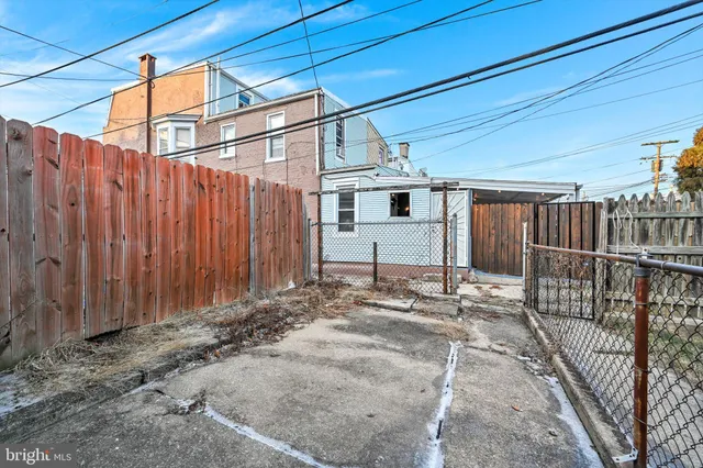 a view of a backyard with wooden fence