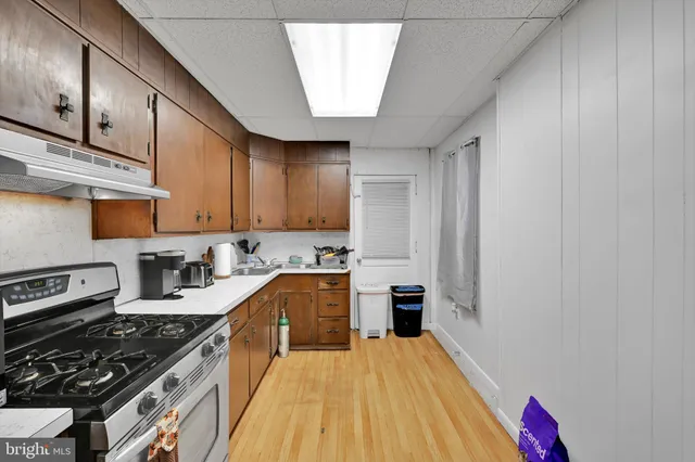a kitchen with stainless steel appliances a stove a sink and a refrigerator