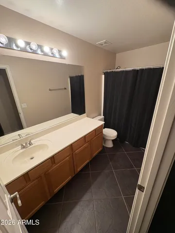 a spacious bathroom with a double vanity sink and a mirror