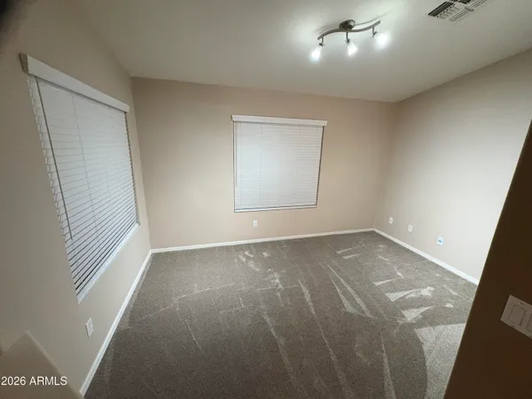 an empty room with a empty space and windows