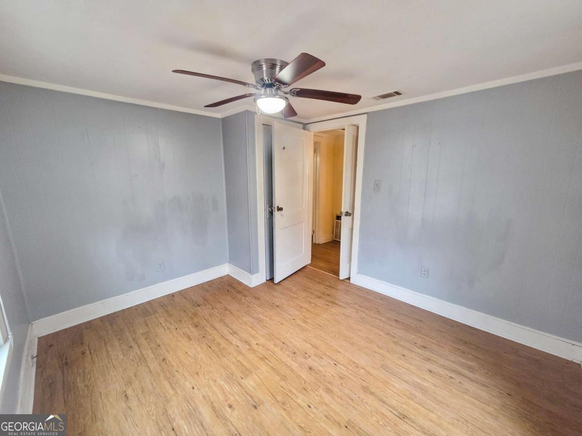 188 Holmesville Road Baxley, GA 31513 - Photo 13 of 20 a view of empty room with wooden floor