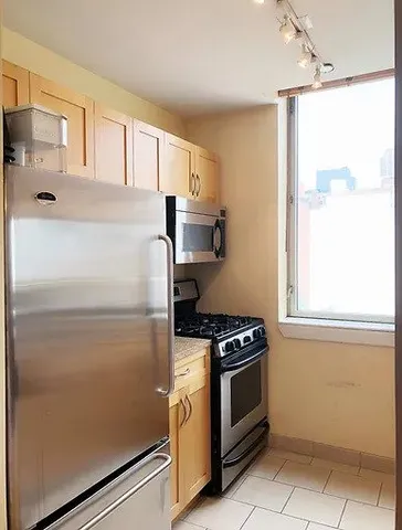 a kitchen with white cabinets and white appliances
