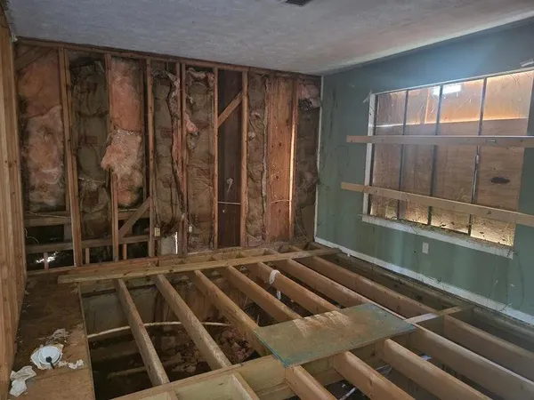 a room with water heater and a glass door shower