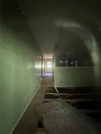 a front view of a house with a tree