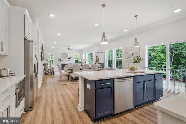 a kitchen with stainless steel appliances granite countertop sink stove and refrigerator