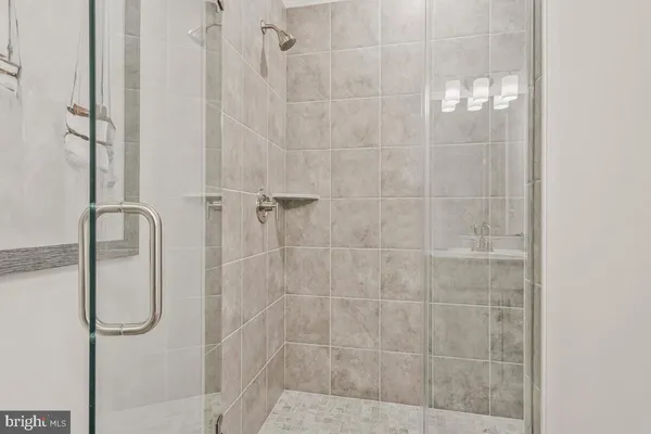 a bathroom with a glass shower door