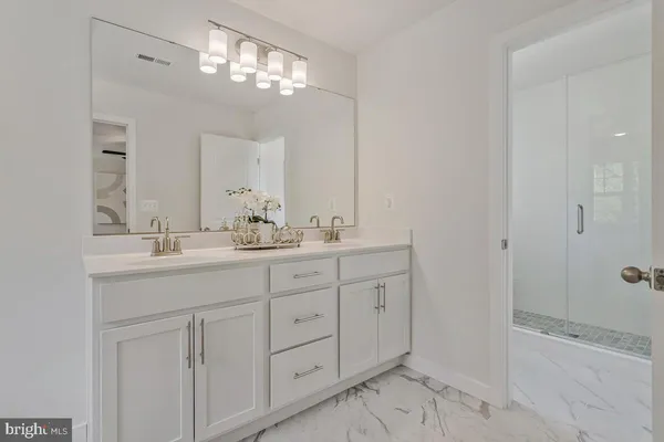 a bathroom with double sink and a mirror