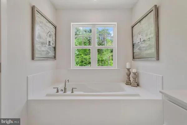 a white bath tub sitting next to a white sink