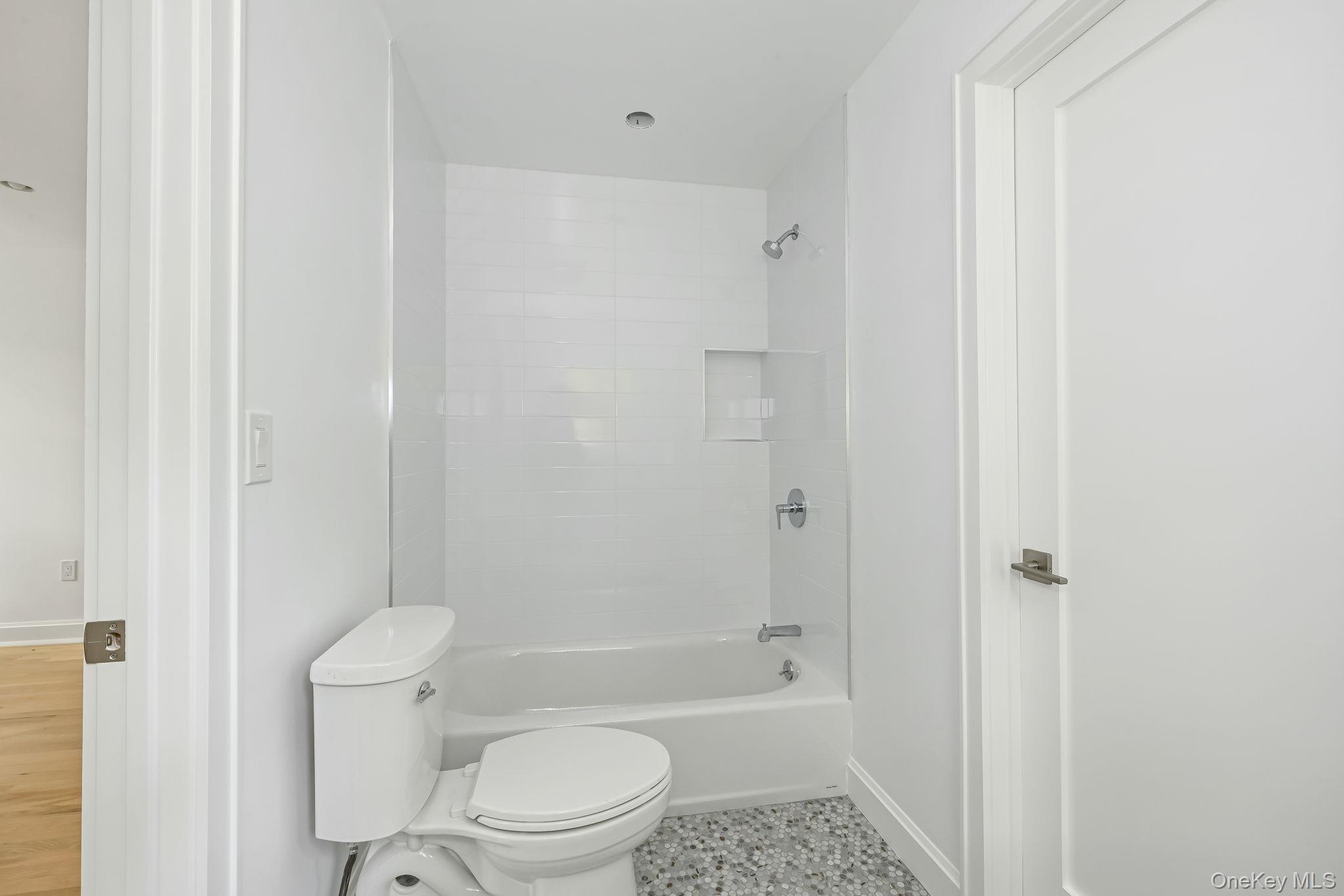 24 Country Road Mamaroneck, NY 10543 - Photo 25 of 37 a bathroom with a toilet and a bath tub