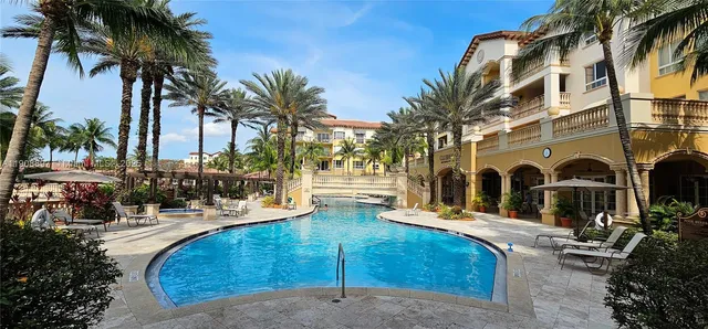 a view of a house with outdoor space and palm trees