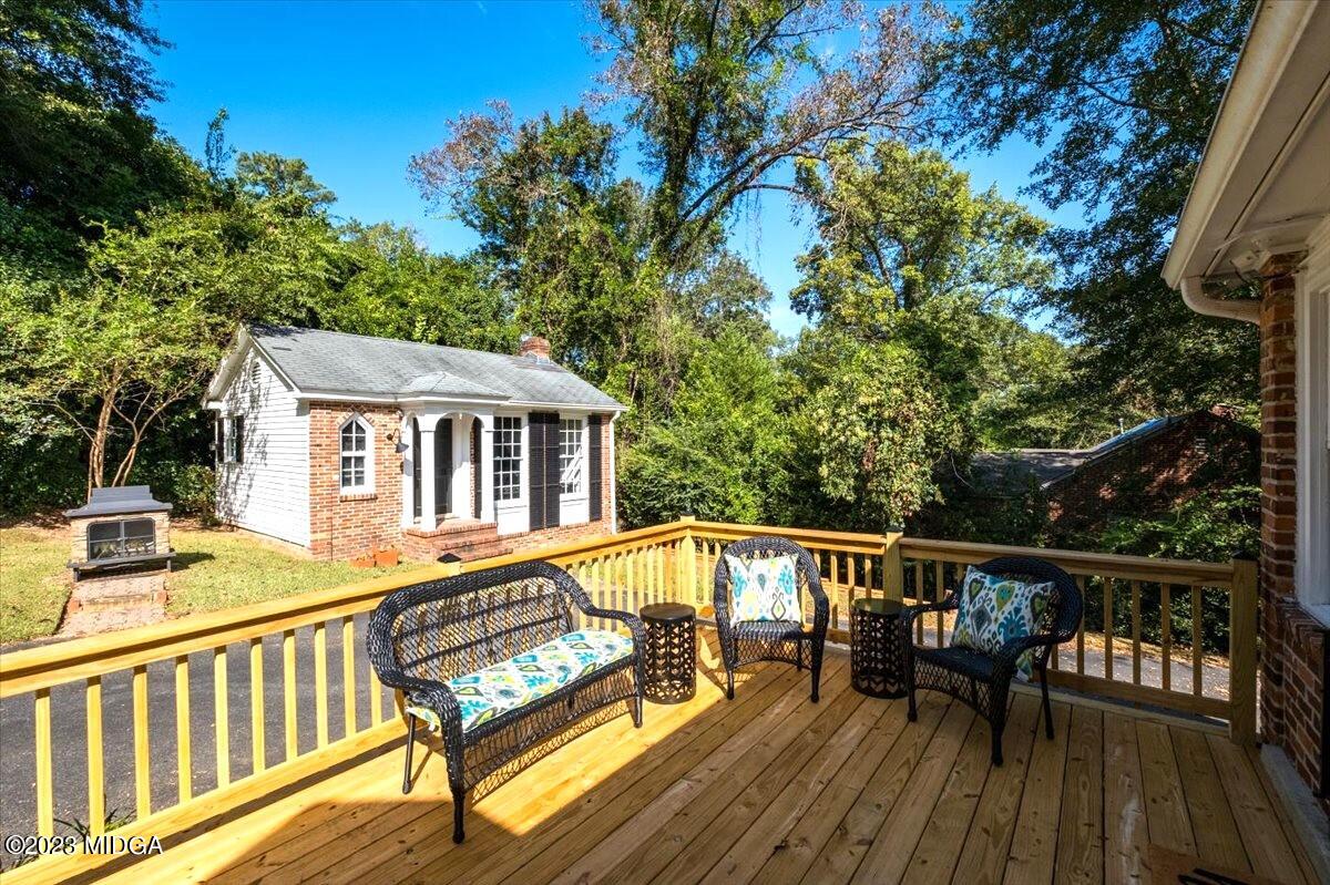 394 Overlook Road Macon, GA 31204 - Photo 24 of 29 a view of a roof deck with table and chairs with wooden floor and fence